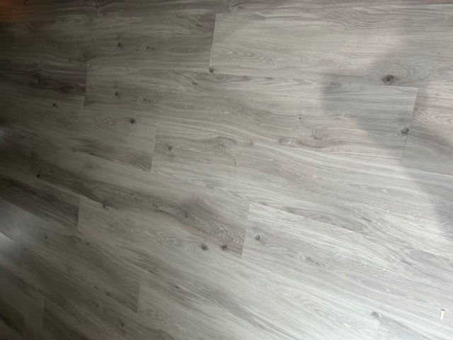 Close-up of gray wood-look plank flooring showing the grain detail in a Las Vegas home