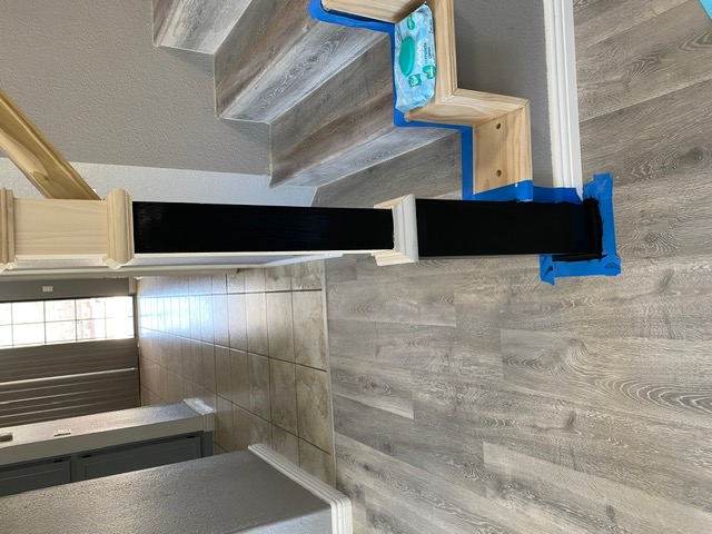 Entryway with new wood-look flooring leading to a staircase in a Las Vegas home