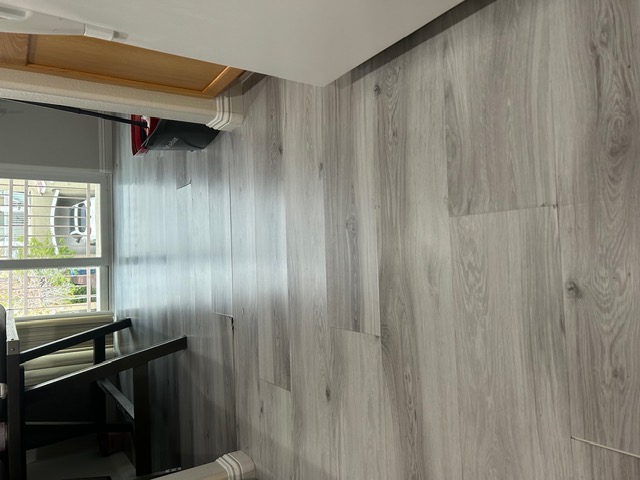 Gray luxury vinyl plank flooring leading to a patio door in a Las Vegas home