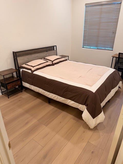 Clean baseboards installed with new wood-look flooring in a Las Vegas bedroom