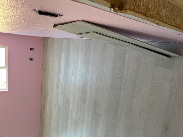 Light gray plank flooring being installed during a Las Vegas room renovation