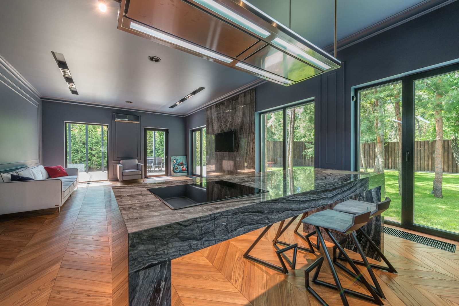 Chevron wood flooring in a modern Las Vegas kitchen with garden views