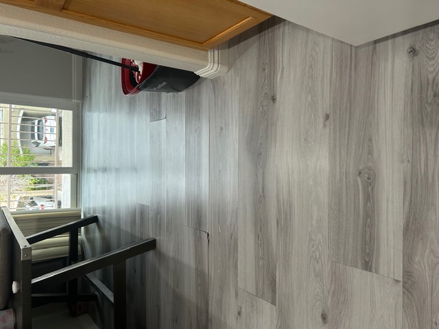Finished gray luxury vinyl plank flooring flowing through a Las Vegas living space