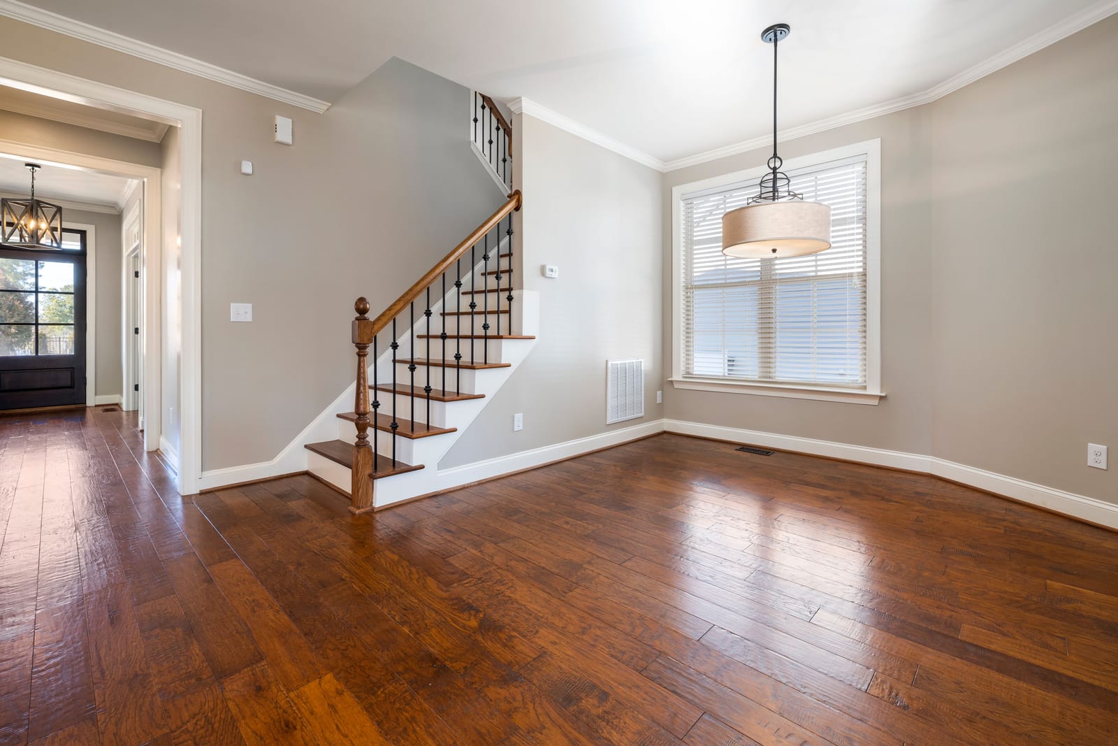 Rich dark hardwood flooring beside a staircase in a Las Vegas home