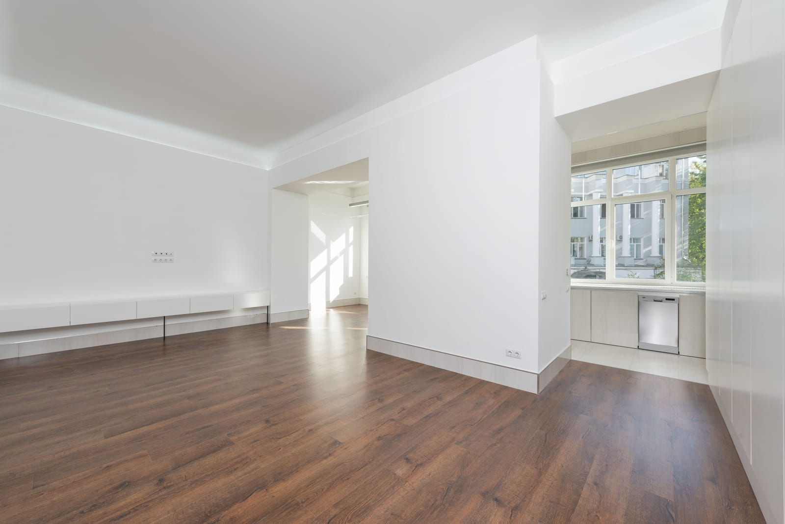 Rich dark walnut wood flooring in a bright, empty Las Vegas room