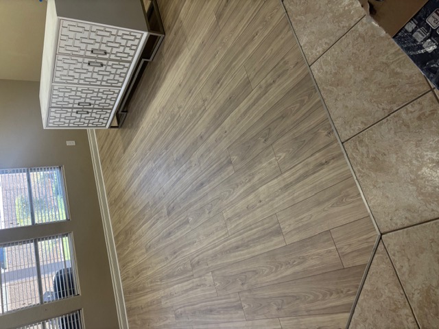 Light engineered wood flooring in a furnished Las Vegas living room