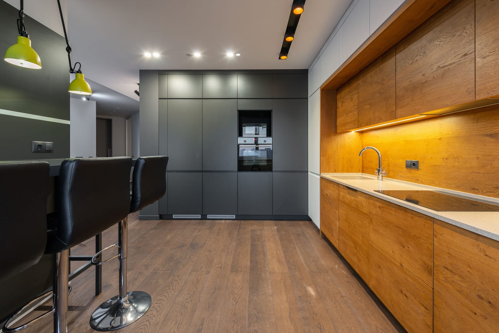 Engineered wood flooring in a contemporary Las Vegas kitchen with gray cabinetry