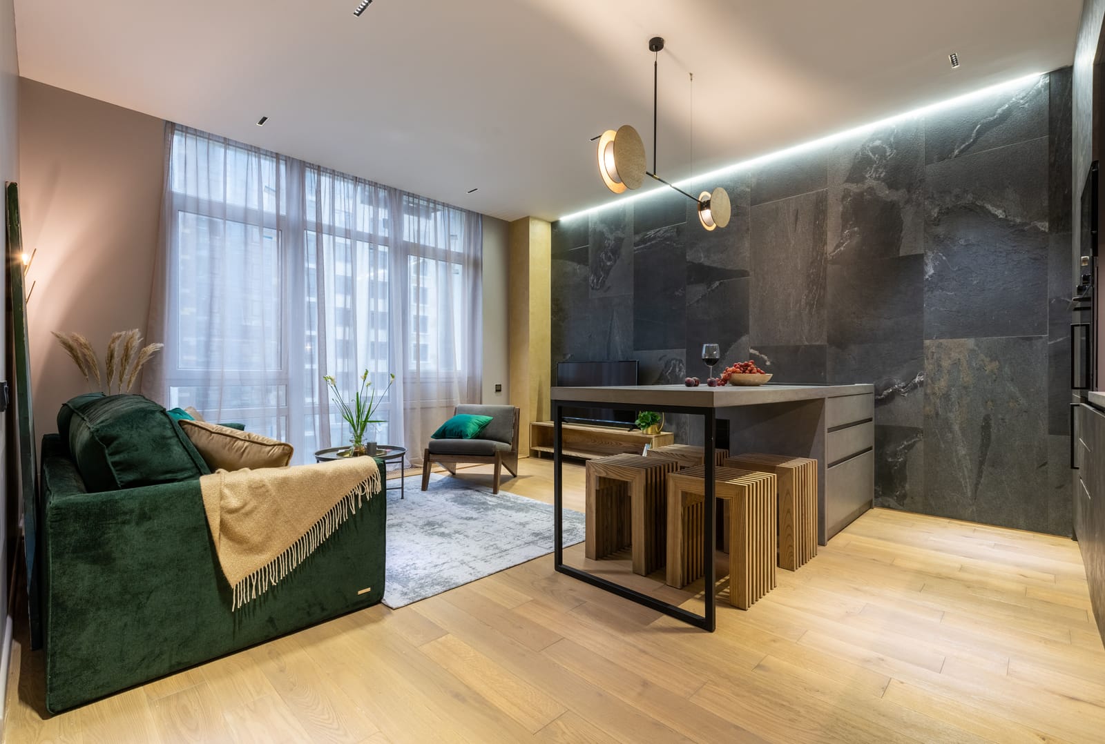 Light oak wood flooring in a modern Las Vegas living room with a green sofa