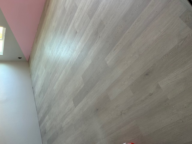 Light whitewashed wood-look flooring in a freshly finished Las Vegas room
