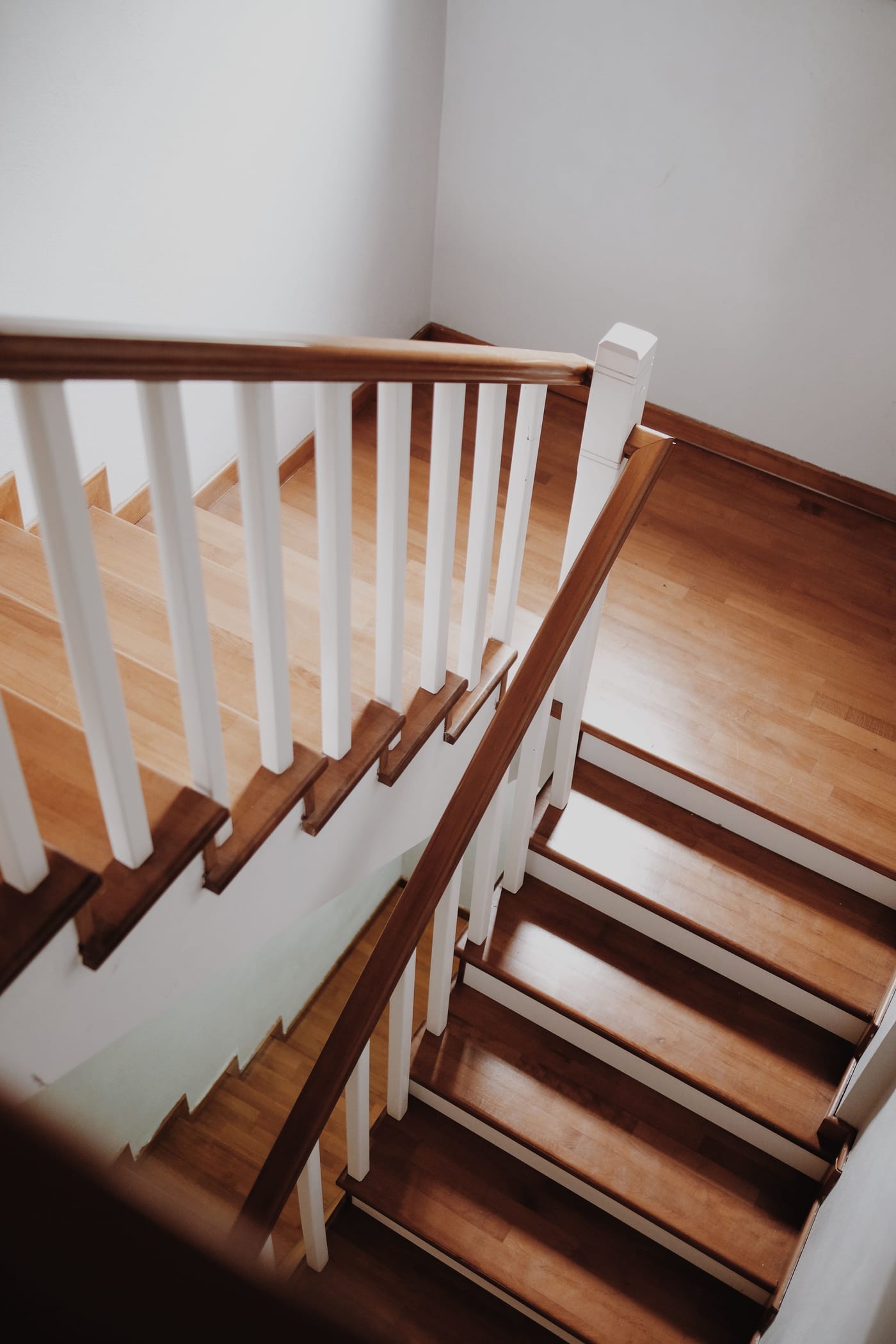 Wood staircase with white risers viewed from the landing in a Las Vegas home